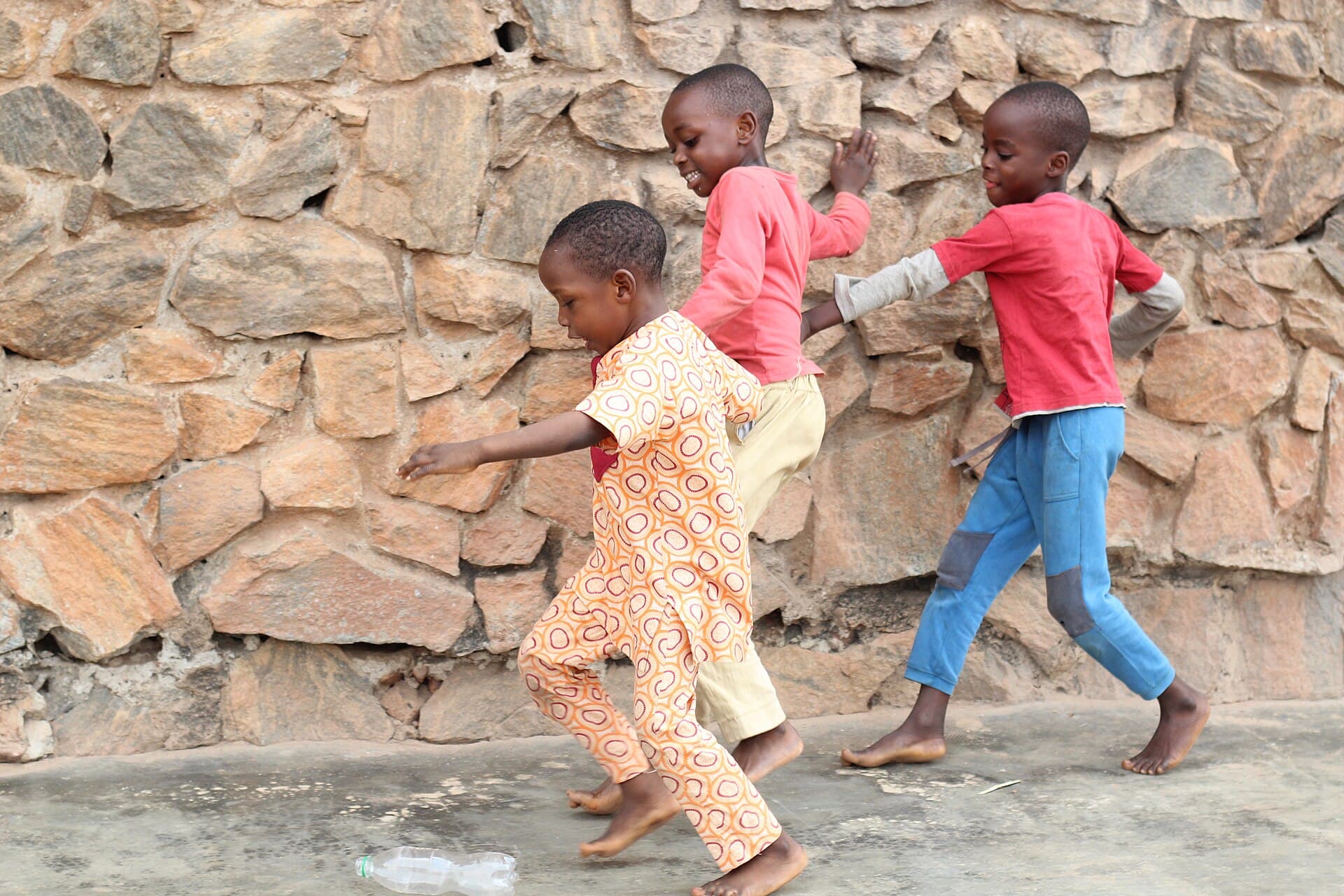 Kids playing ball using water bottle