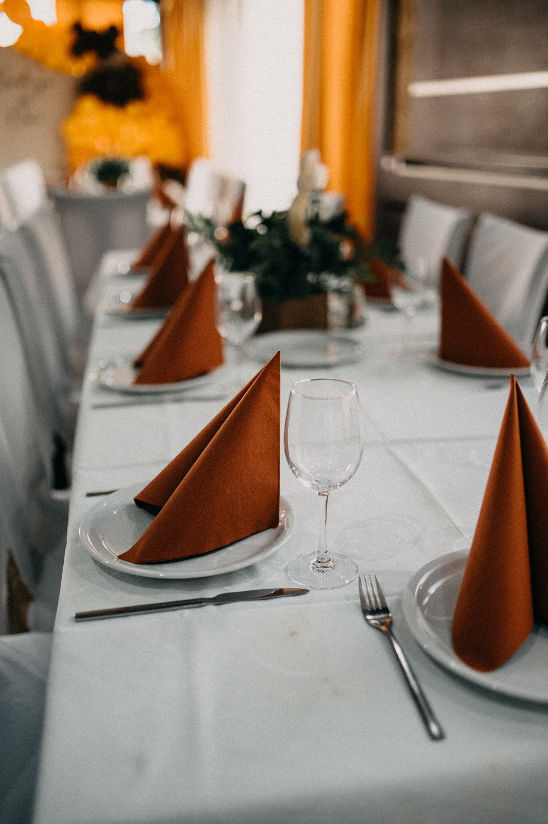 A beautifully arranged dining table showcases white tablecloths