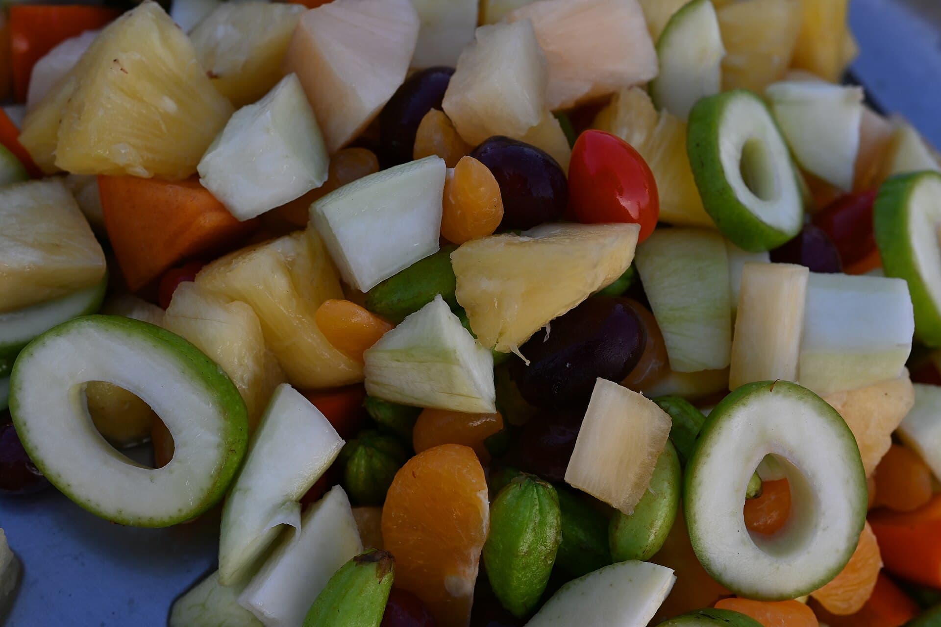 DFC 3934 A colorful medley of freshly chopped fruits - pineapple grapes apple rings papaya and apricot pieces