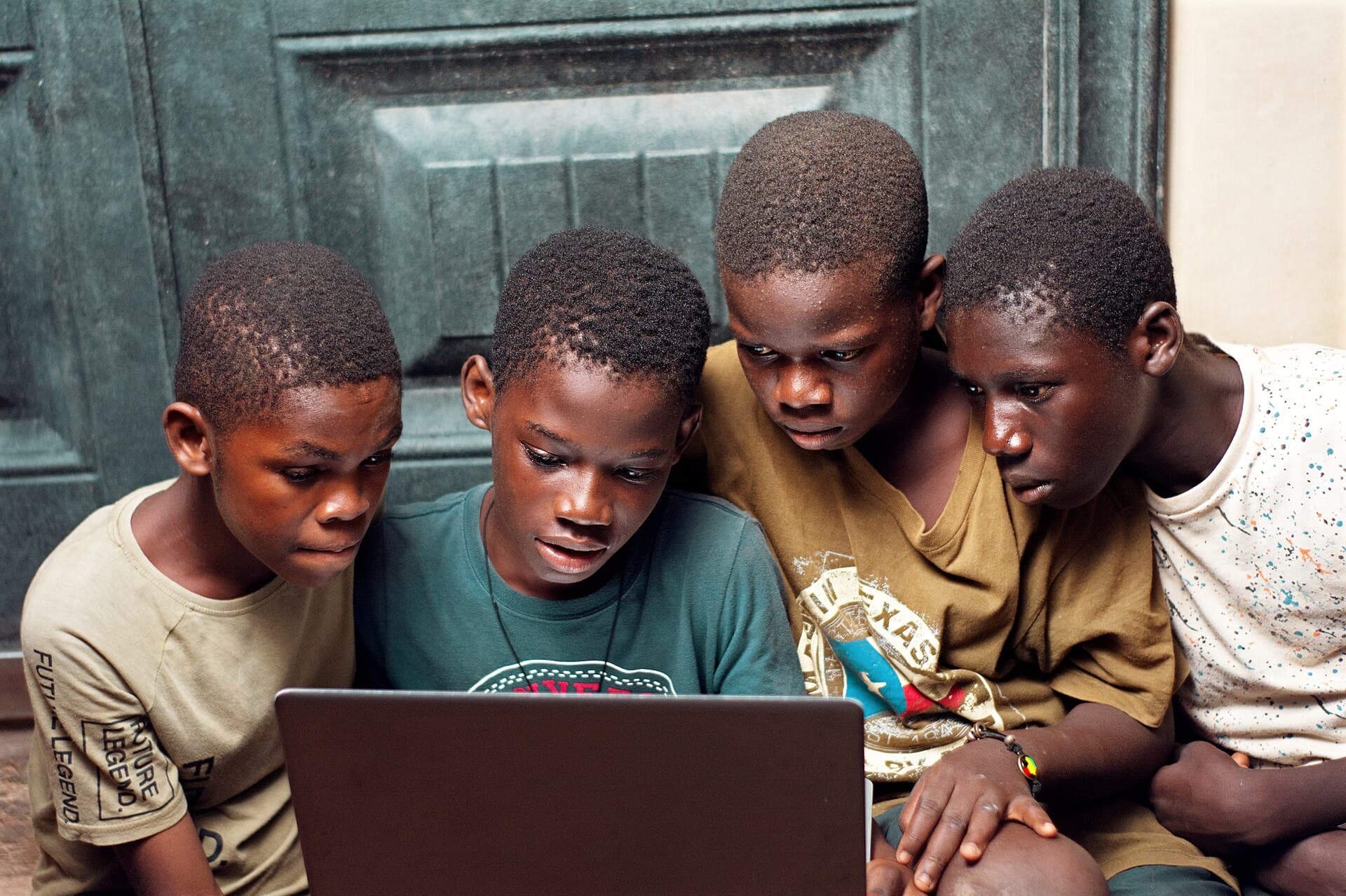 A group of boys using a laptop at home 03