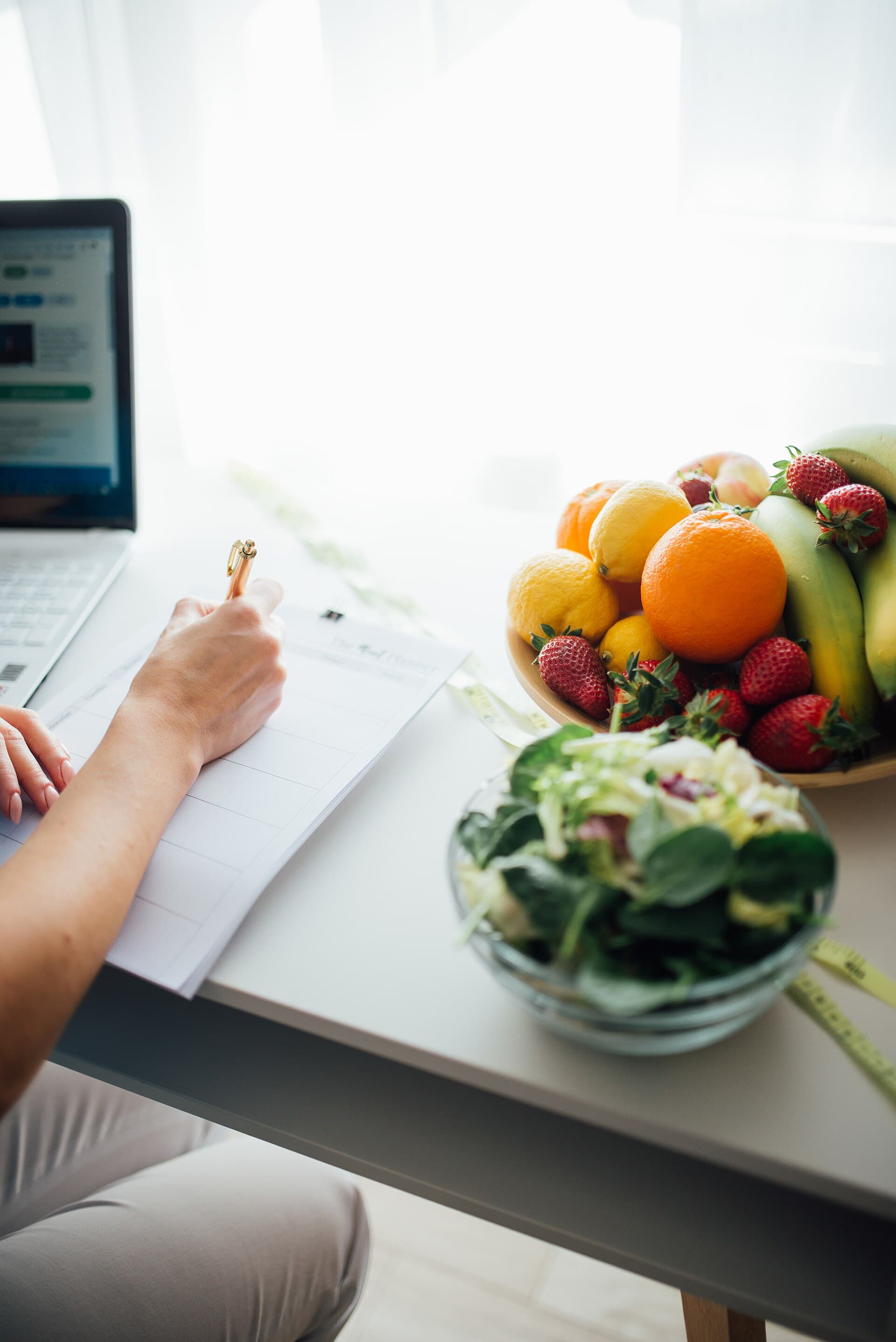 Healthy meal planning with fresh fruits and vegetables in a bright kitchen setting