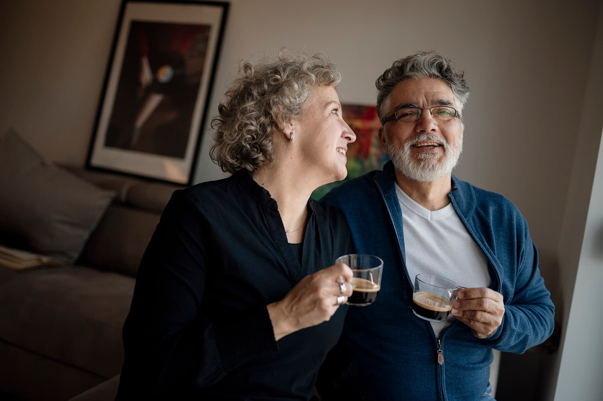 Couple enjoying coffee together in their cozy living room