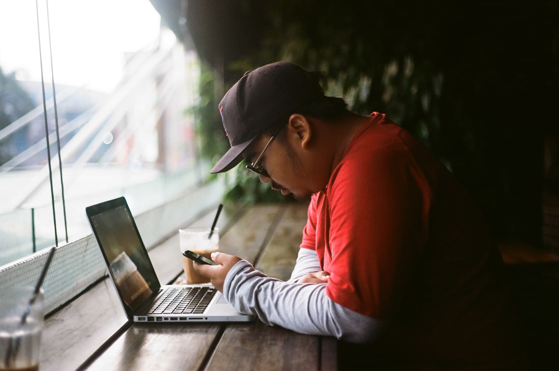 Man sitting with laptop (Unsplash)
