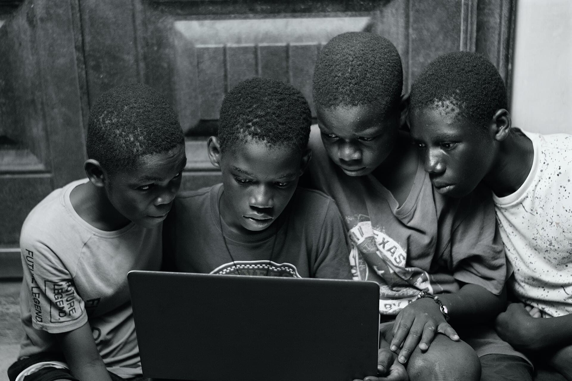 A group of boys using a laptop 02