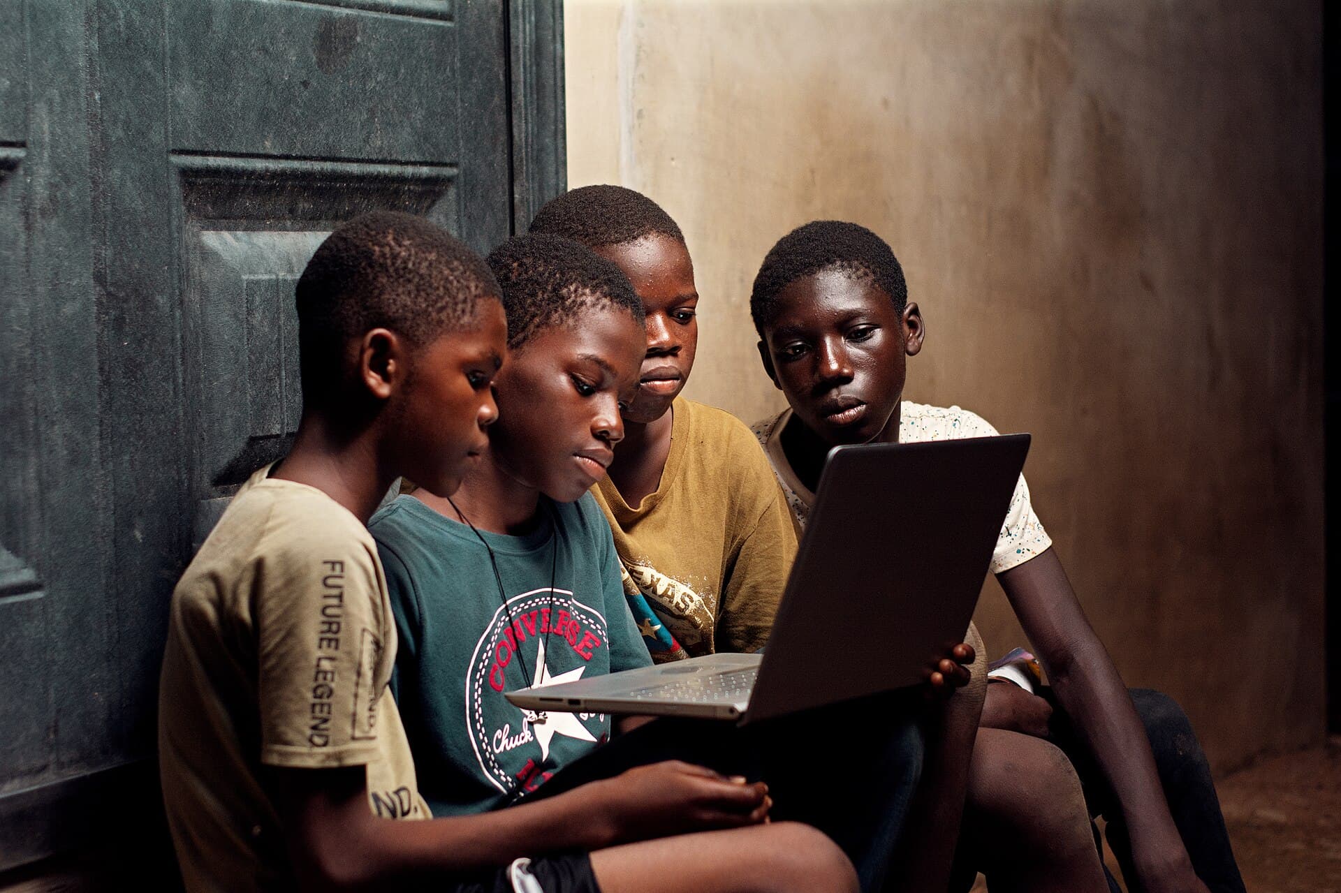 A group of boys using a laptop 05