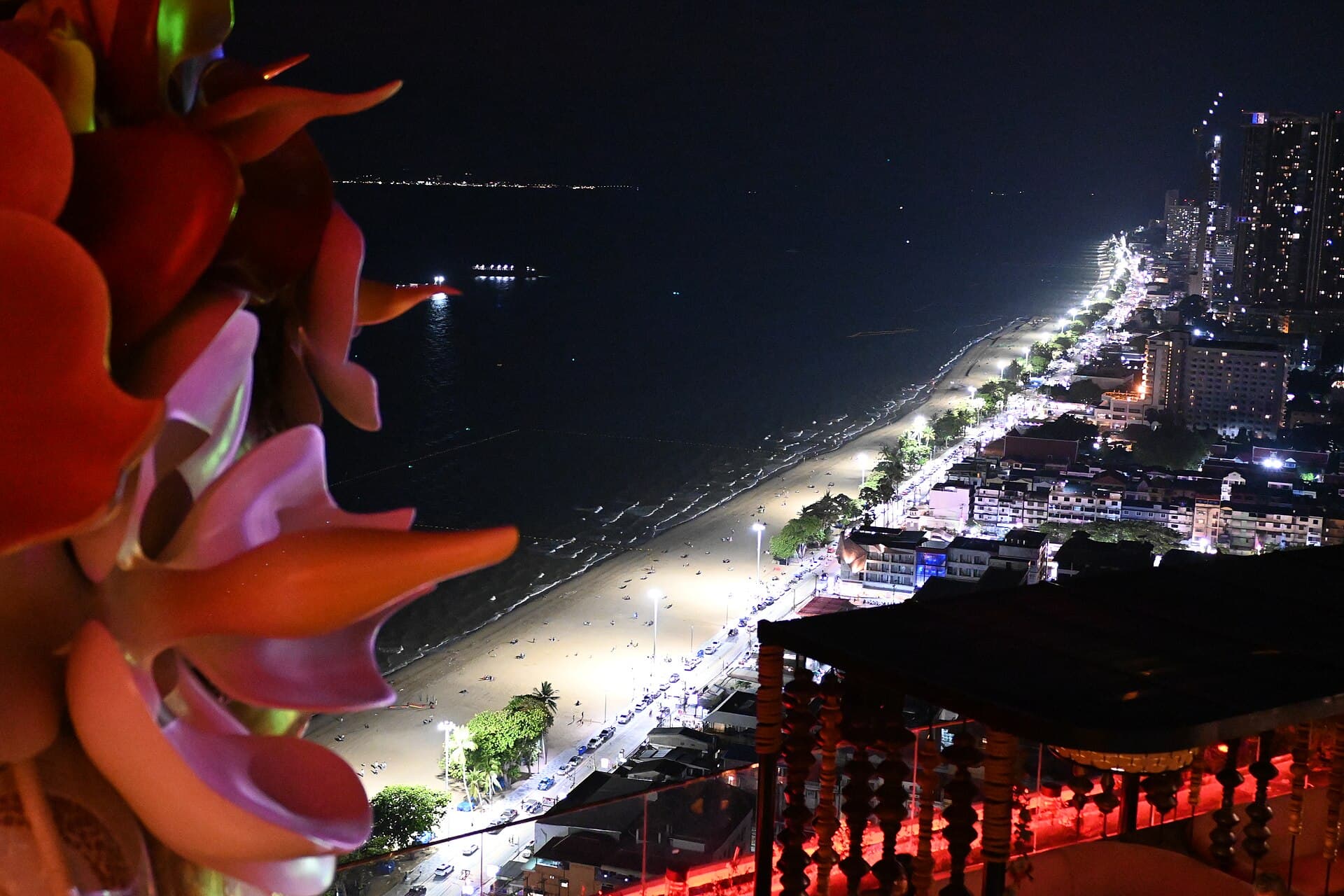 DFC 5169 Pattaya by night a glittering coastline and palm-lined beach stretching into the lights of the city