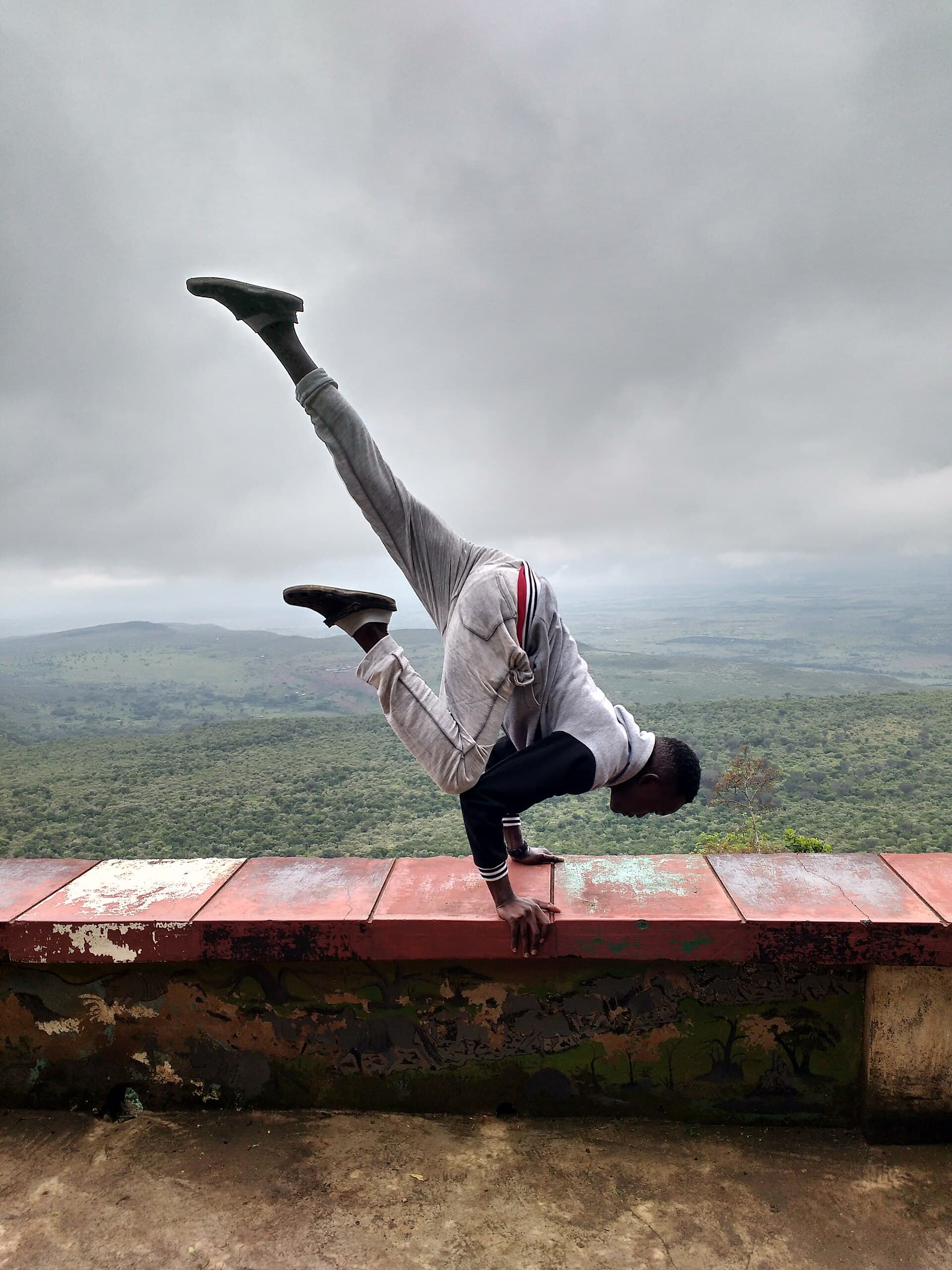 A young man performs a yoga pose at the Rift Valley Escarpment along Nairobi-Mai Mahiu Road